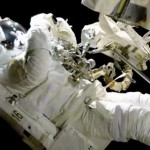 Spacewalking astronaut brings focus to camera on space station