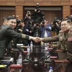 South Korean Maj. Gen. Kim Do-gyun, left, shakes hands with his North Korean counterpart Lt. Gen. An Ik San