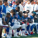 Buffalo Bills players take a knee during the playing of the national anthem