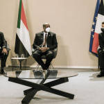 French President Emmanuel Macron attends the ceremony with Sudanese Prime Minister Abdullah Hamdouk and military ruler General Abdel Fattah Burhan.