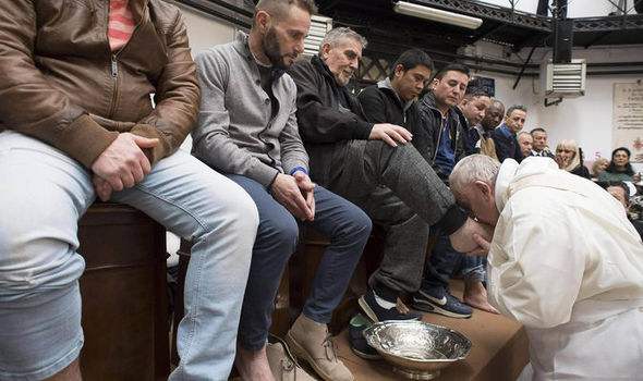 Pope Francis washing and kissing the feet of 12 prison inmates, including two Muslims